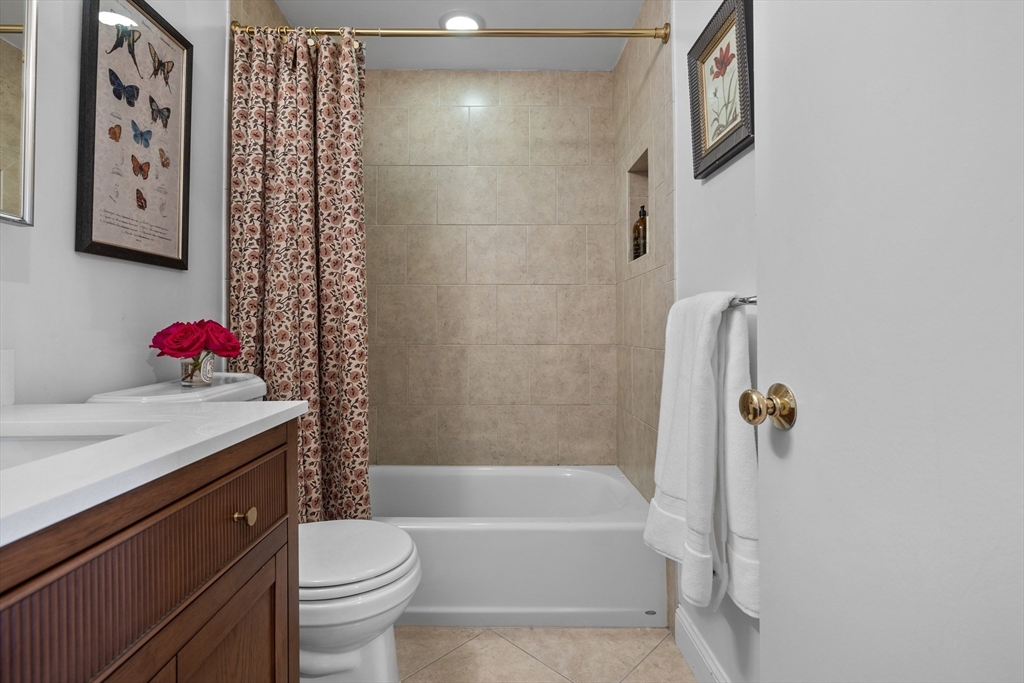 88 Worcester Street, Unit 4 Boston, MA 02118 - Photo 18 of 24 a bathroom with a granite countertop sink and a mirror