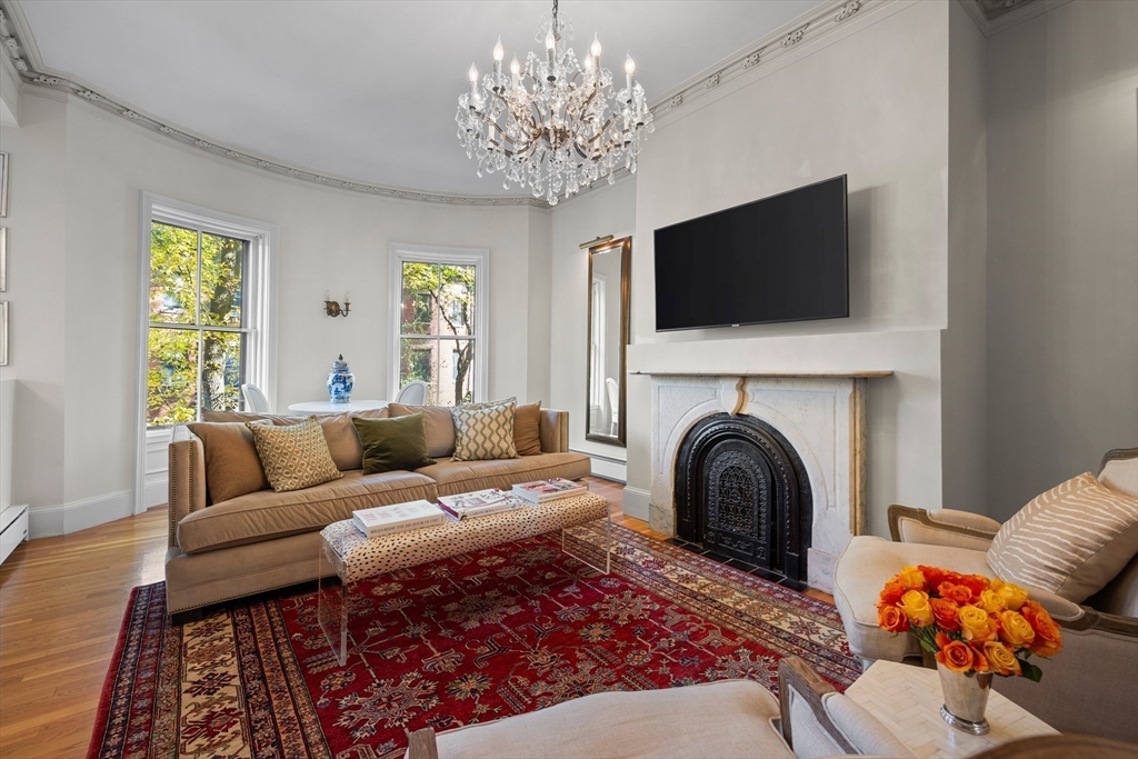 88 Worcester Street, Unit 4 Boston, MA 02118 - Photo 2 of 24 a living room with furniture a flat screen tv and a fireplace