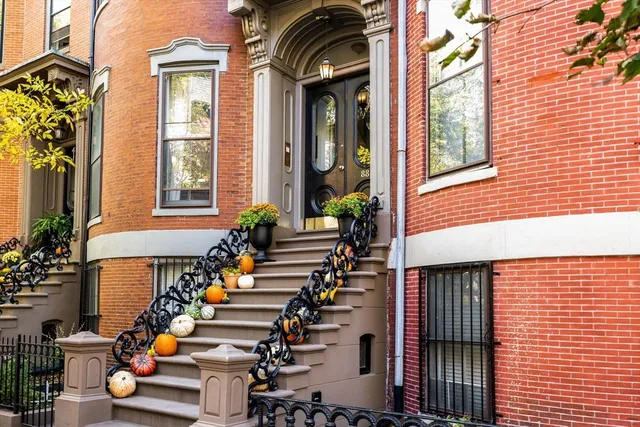 a front view of a house with outdoor seating