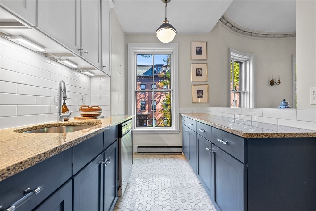 88 Worcester Street, Unit 4 Boston, MA 02118 - Photo 10 of 24 a bathroom with a granite countertop sink a toilet and window