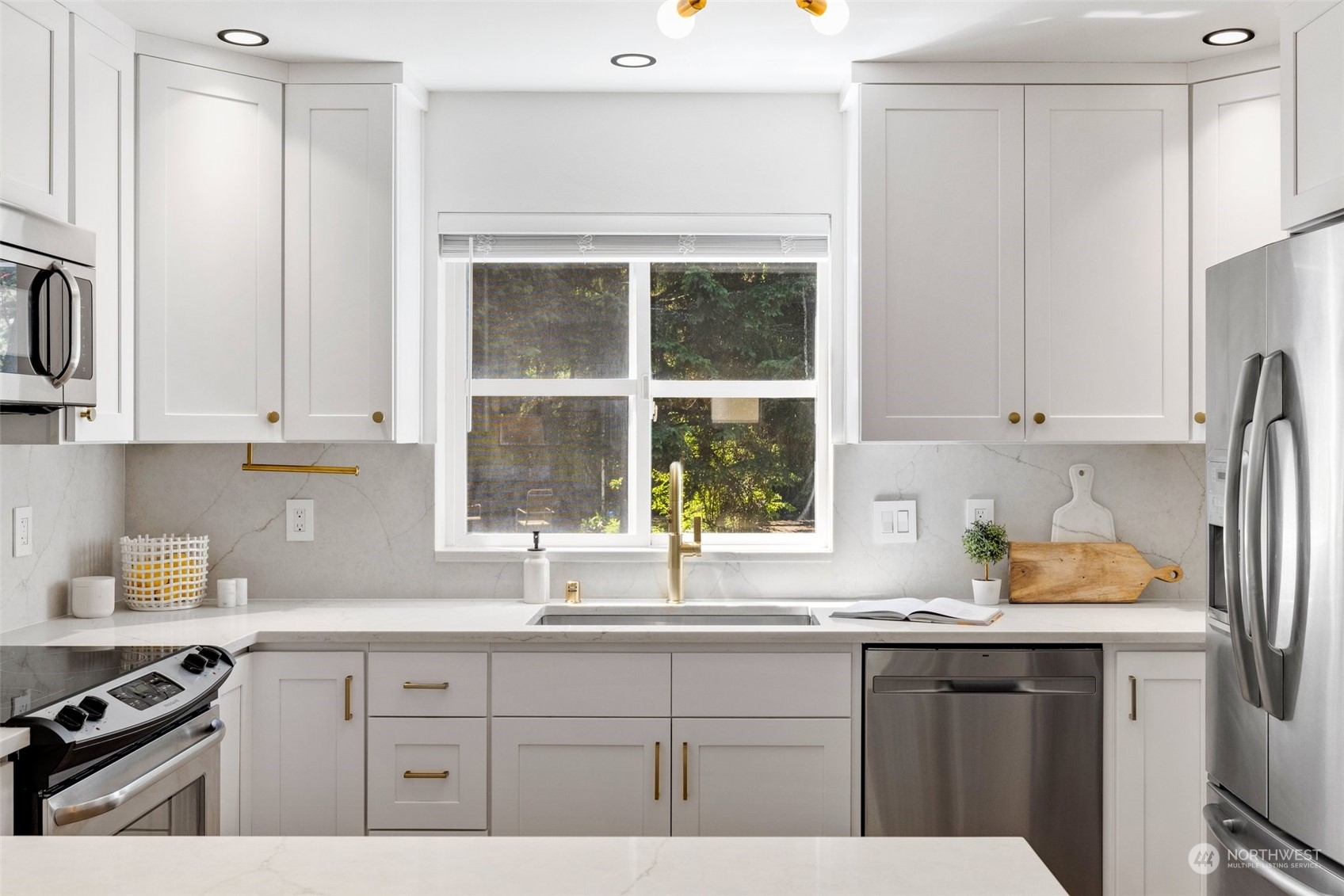 3613 22nd Avenue West, Unit B Seattle, WA 98199 - Photo 13 of 35 a kitchen with stainless steel appliances granite countertop a sink a stove and a white refrigerator with wooden cabinets