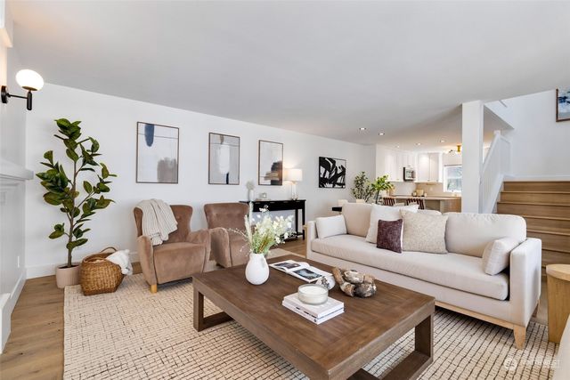 a living room with furniture kitchen view and a table