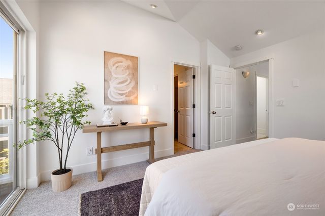 a bedroom with a bed and a potted plant