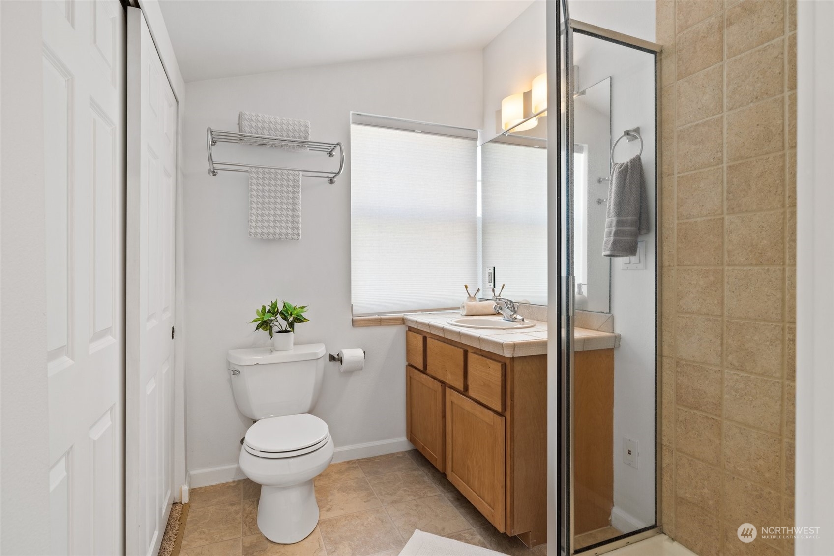 3613 22nd Avenue West, Unit B Seattle, WA 98199 - Photo 26 of 35 a bathroom with a granite countertop sink toilet and shower