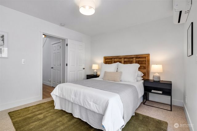 a bedroom with a bed and a night stand