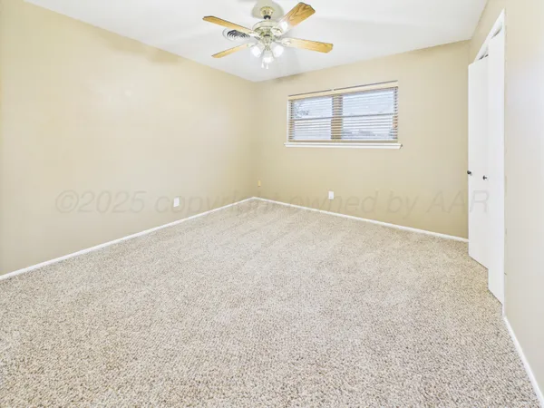 a view of an empty room with a window