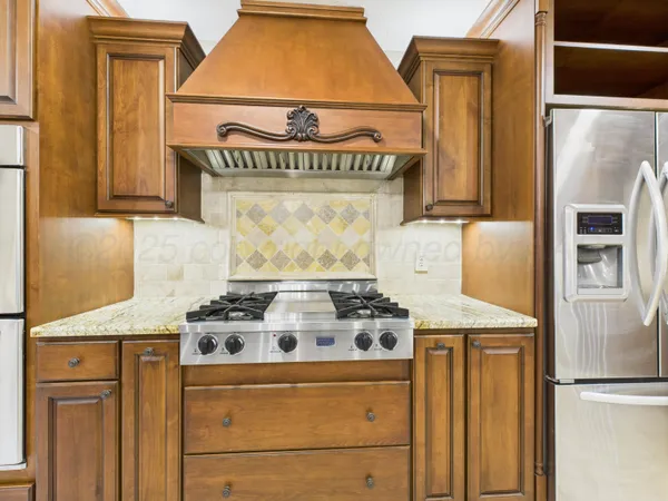 a kitchen with a stove and a refrigerator