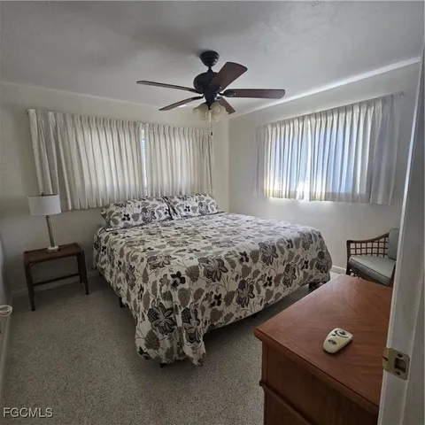a bathroom with a granite countertop sink mirror vanity and toilet