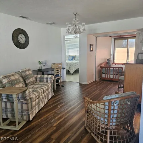 a living room with furniture a table and a chandelier