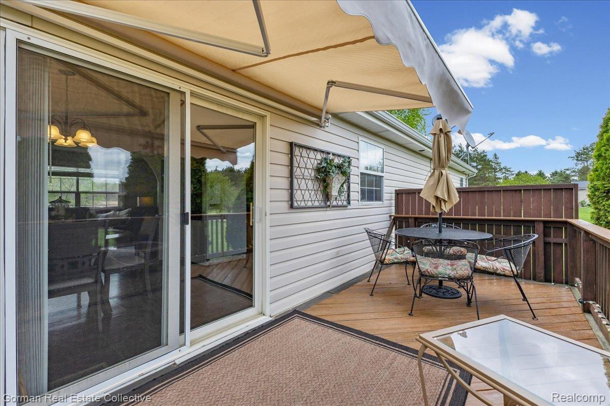 3457 West Burnside Road Columbiaville, MI 48421 - Photo 26 of 45 Wooden deck with outdoor dining space and covered awning