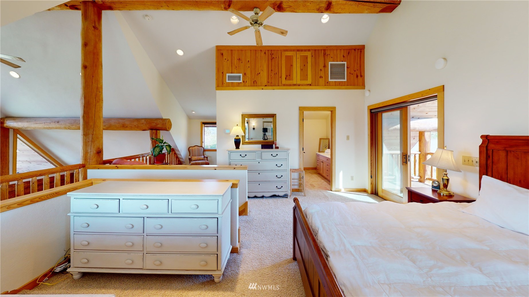 20 Pony Road Winthrop, WA 98862 - Photo 21 of 40 a spacious bedroom with a bed a mirror and windows