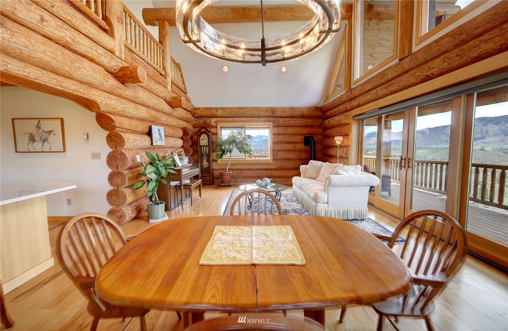 20 Pony Road Winthrop, WA 98862 - Photo 10 of 40 a view of a dining room with furniture a chandelier and wooden floor