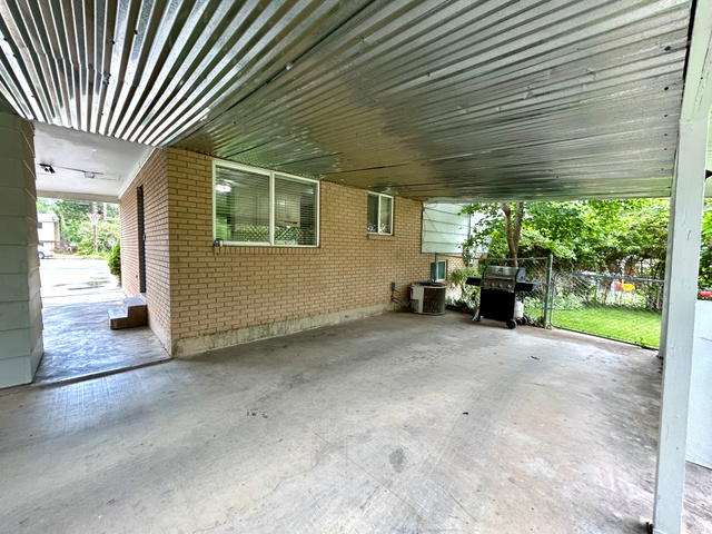 441 South 400 East Payson, UT 84651 - Photo 30 of 39 Covered patio featuring a corrugated metal ceiling, concrete flooring, and brick exterior wall