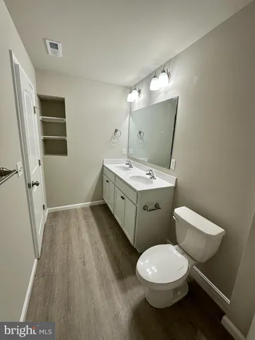 a bathroom with a toilet sink and mirror
