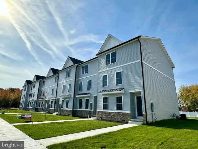 a front view of building with yard
