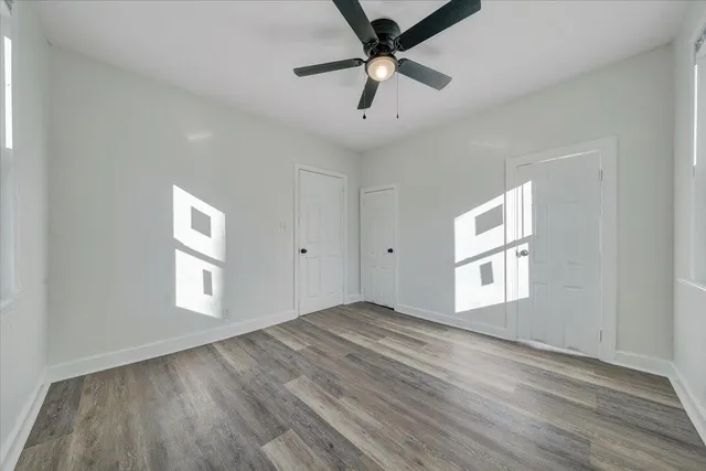 wooden floor in an empty room with a window