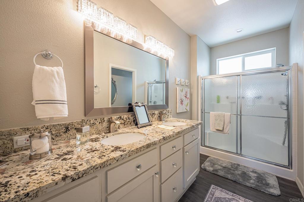 4650 Dulin Road, Unit 192 Fallbrook, CA 92003 - Photo 24 of 42 a bathroom with a granite countertop sink and a mirror