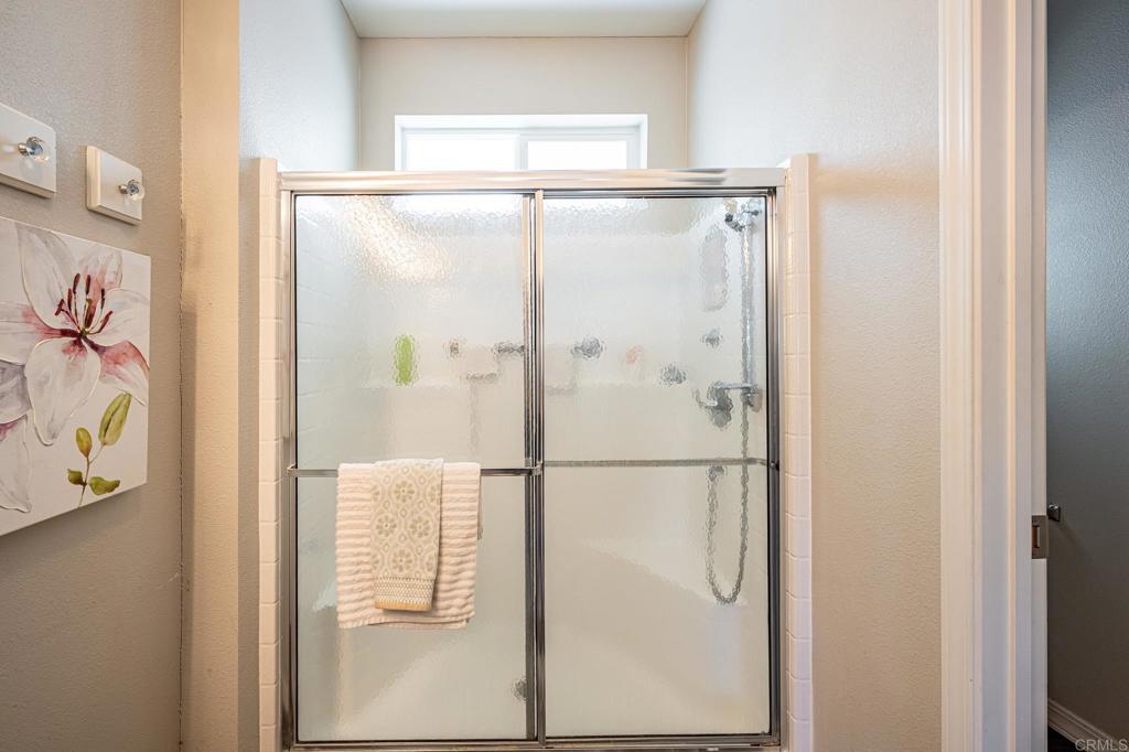 4650 Dulin Road, Unit 192 Fallbrook, CA 92003 - Photo 26 of 42 a bathroom with a glass shower door