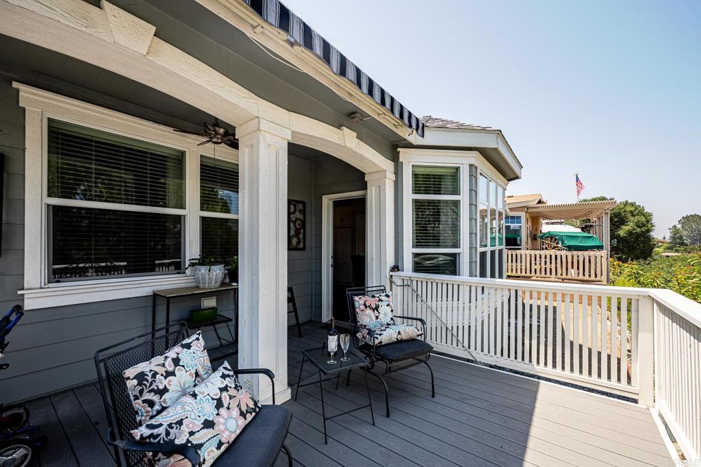 4650 Dulin Road, Unit 192 Fallbrook, CA 92003 - Photo 30 of 42 a balcony with furniture and wooden floor