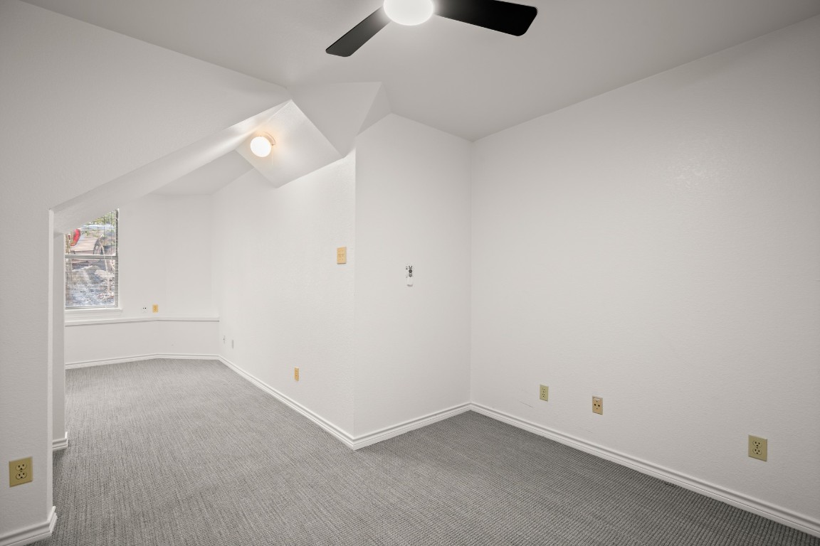 4906 Bob Cat Run Austin, TX 78731 - Photo 24 of 37 Additional living space with carpet, lofted ceiling, and ceiling fan