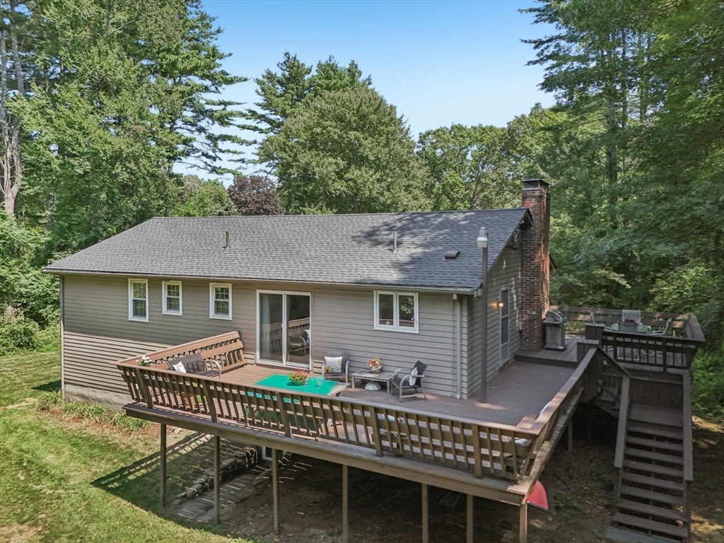 318 Harvard Road Stow, MA 01775 - Photo 3 of 40 a front view of a house with a wooden deck and furniture