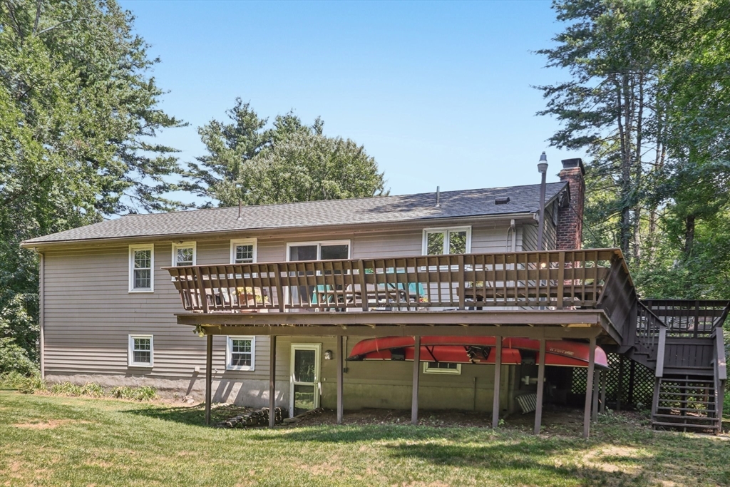 318 Harvard Road Stow, MA 01775 - Photo 5 of 40 a front view of a house with swimming pool and glass top table and chairs