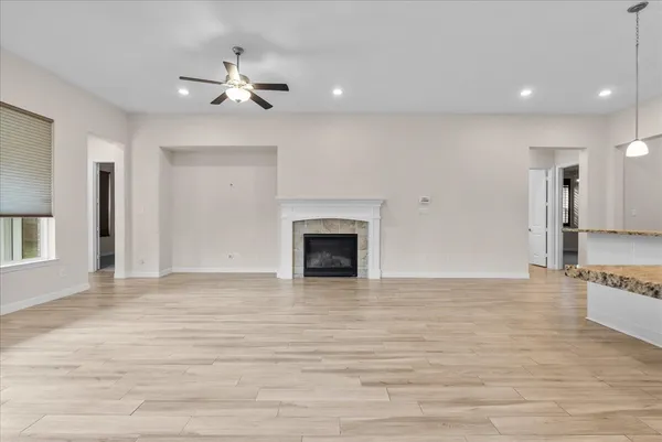 a spacious bathroom with a granite countertop sink a mirror and a vanity