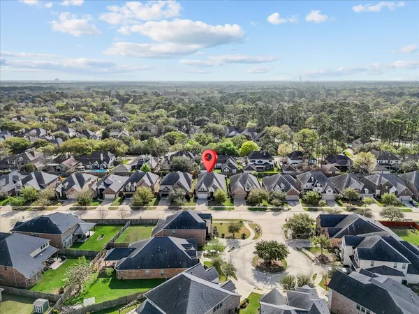 a large kitchen with stainless steel appliances kitchen island a large counter top and a wooden floors