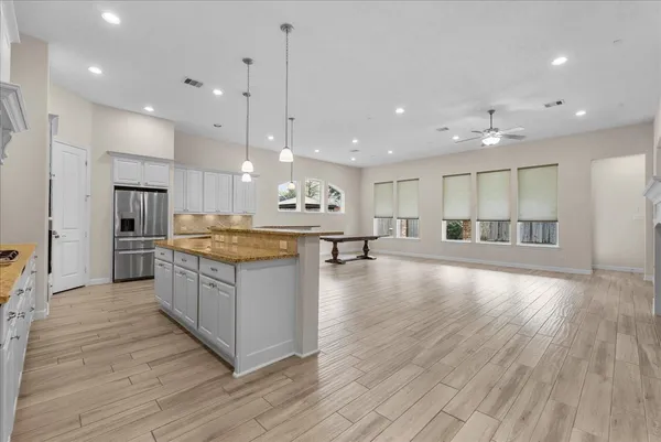 a kitchen with granite countertop a sink a counter space stainless steel appliances and cabinets