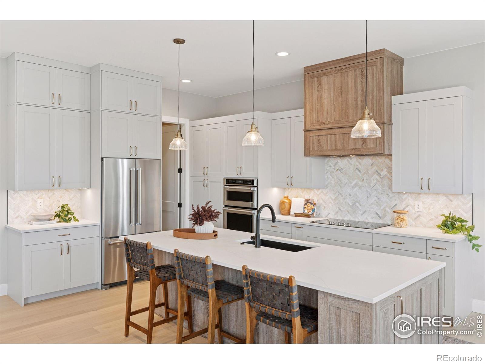 953 William Way Berthoud, CO 80513 - Photo 6 of 20 a kitchen with stainless steel appliances kitchen island granite countertop a table chairs and a refrigerator