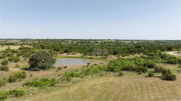 a view of a lake with houses in the back