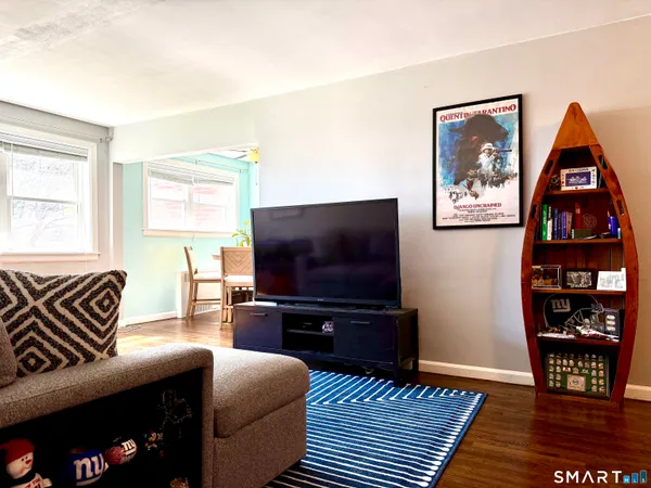 a bedroom with furniture and a wooden floor