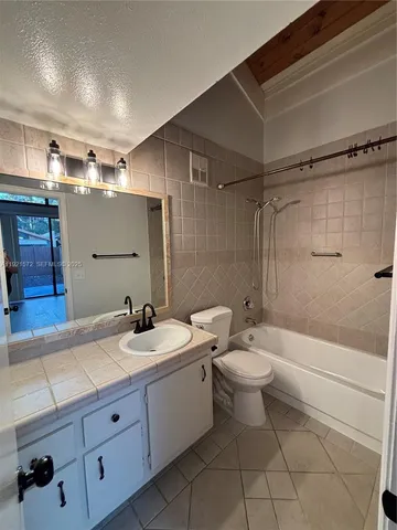 a bathroom with a double vanity sink toilet and shower