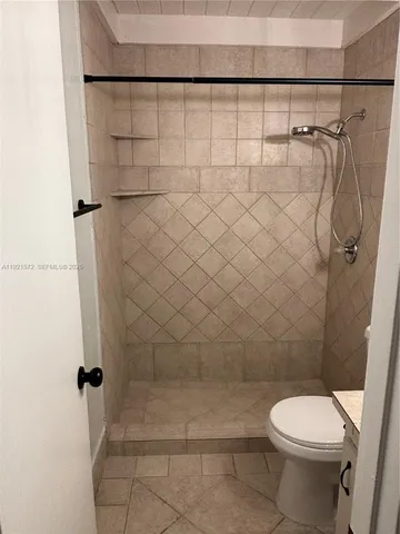 a bathroom with a toilet and a shower