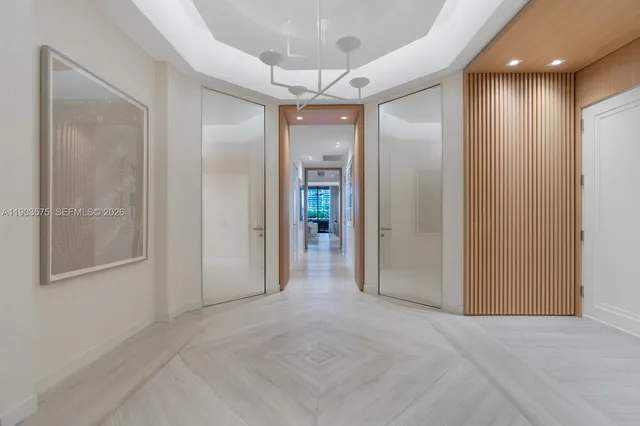 a view of a balcony with chairs and wooden floor