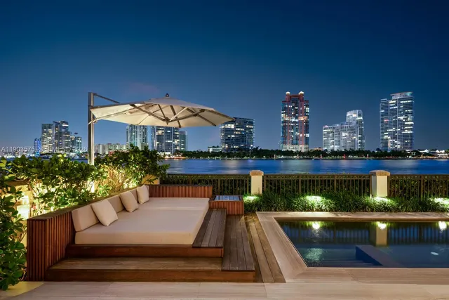 a view of a patio with couches table and chairs and potted plants
