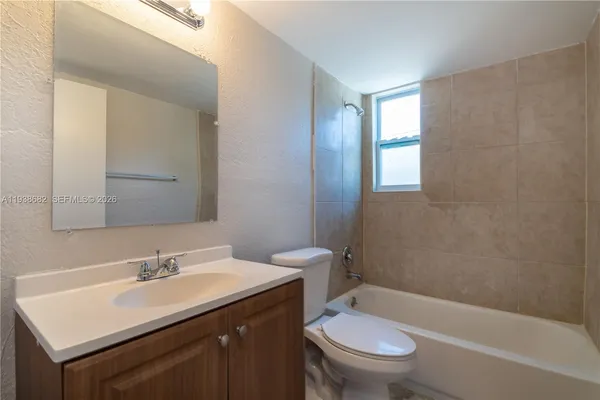 a bathroom with a sink toilet vanity and shower