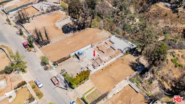 an aerial view of a house with a yard