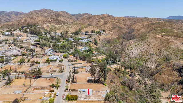 an aerial view of residential house and sandy dunes