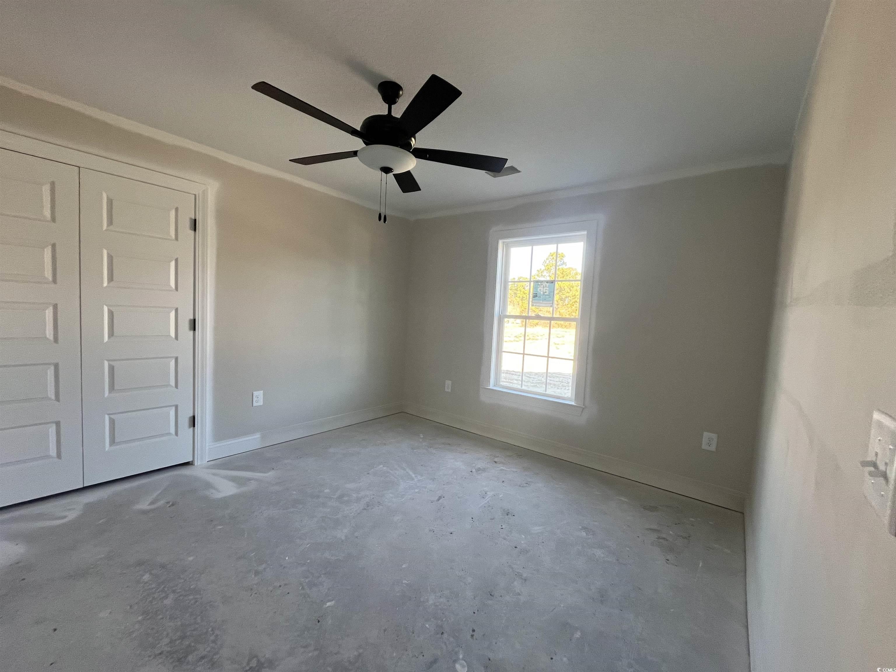 479 Highway 348 Loris, SC 29569 - Photo 12 of 13 Spare room with crown molding and ceiling fan