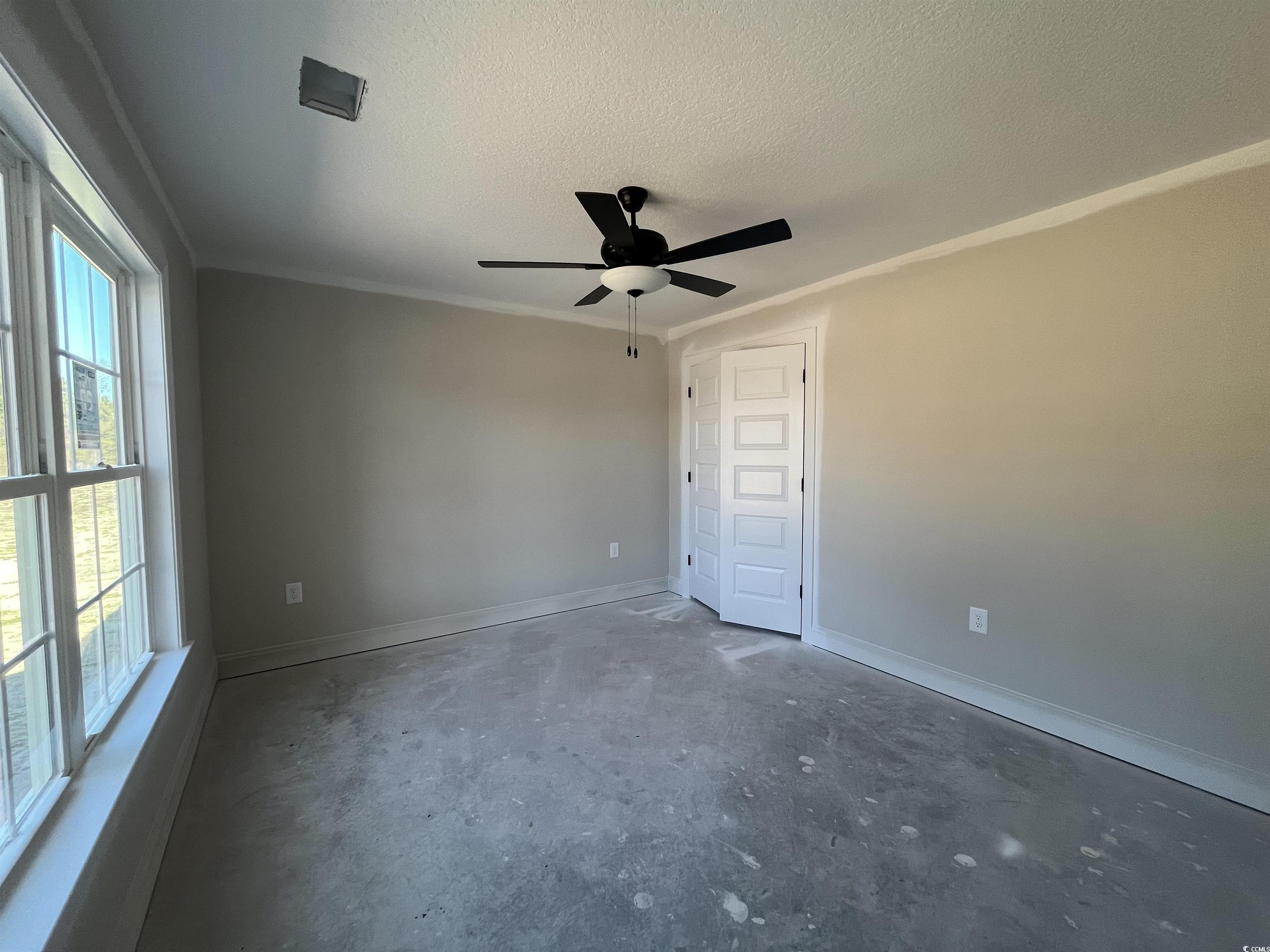 479 Highway 348 Loris, SC 29569 - Photo 9 of 13 Spare room with crown molding, ceiling fan, and a