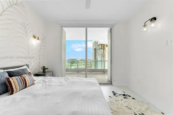 a bedroom with a large bed and a window