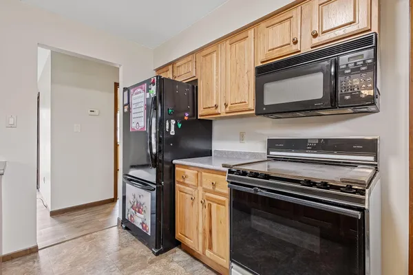 a kitchen with microwave cabinets and stainless steel appliances