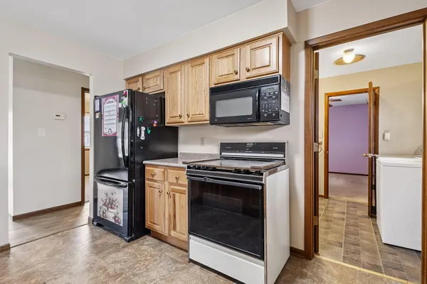 a kitchen with stainless steel appliances granite countertop a stove microwave and refrigerator