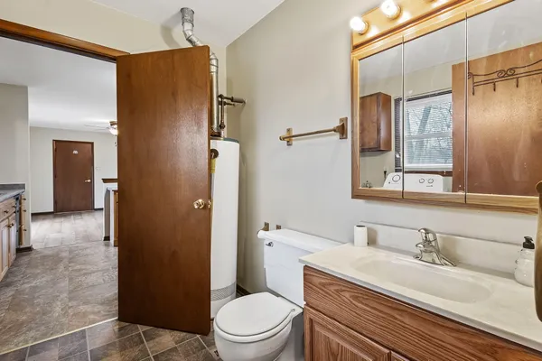 a bathroom with a granite countertop sink toilet and shower