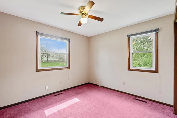 a view of a room with a ceiling fan