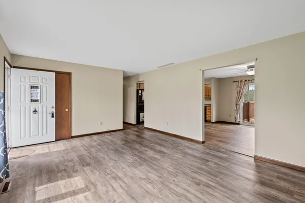 a view of a livingroom with wooden floor and closet