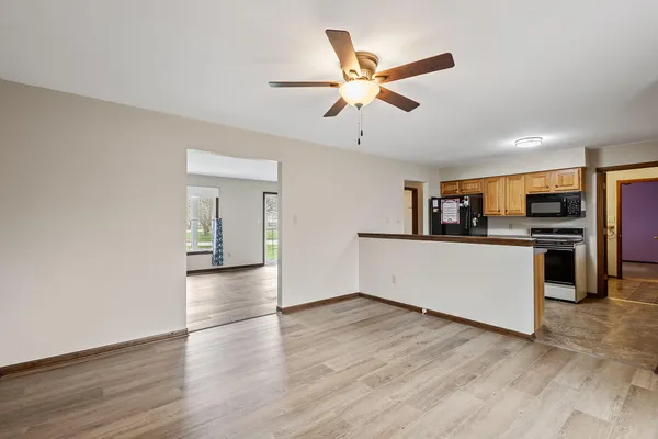 a view of a kitchen with a sink stainless steel appliances and cabinets