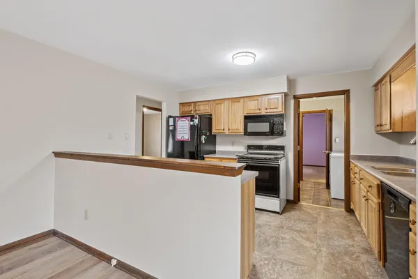 a kitchen with stainless steel appliances a refrigerator and a stove top oven