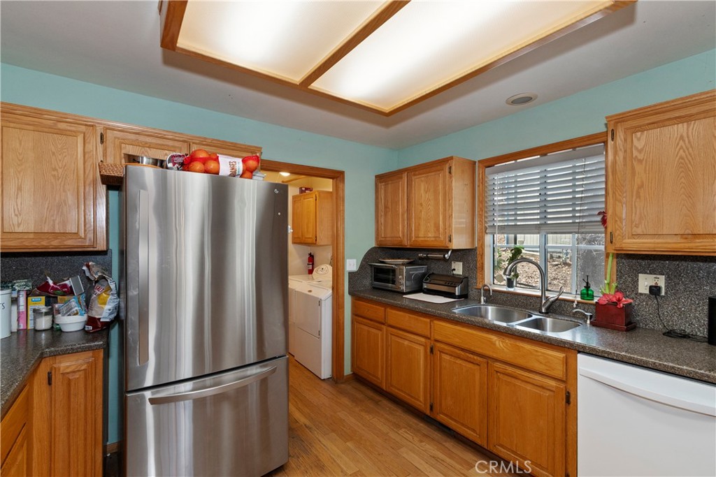 28223 North Bay Road Lake Arrowhead, CA 92352 - Photo 12 of 39 a kitchen with stainless steel appliances a refrigerator sink and cabinets